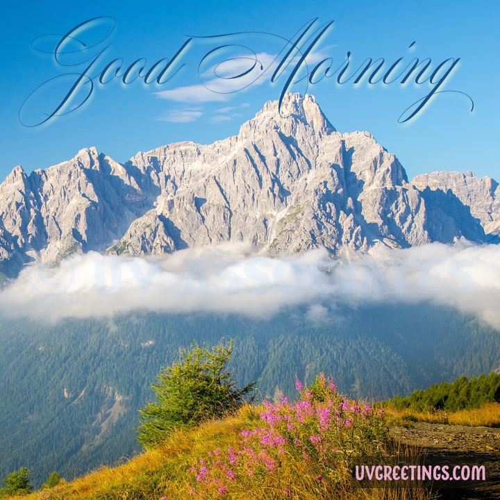 Clouds and Mountains with blue skies and beautiful good morning lettering