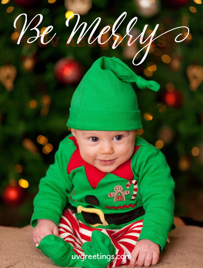 Baby wearing a green elf dress to wish you to be merry